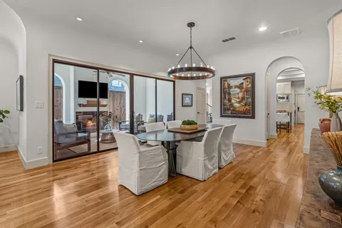a living room with fireplace furniture and a wooden floor