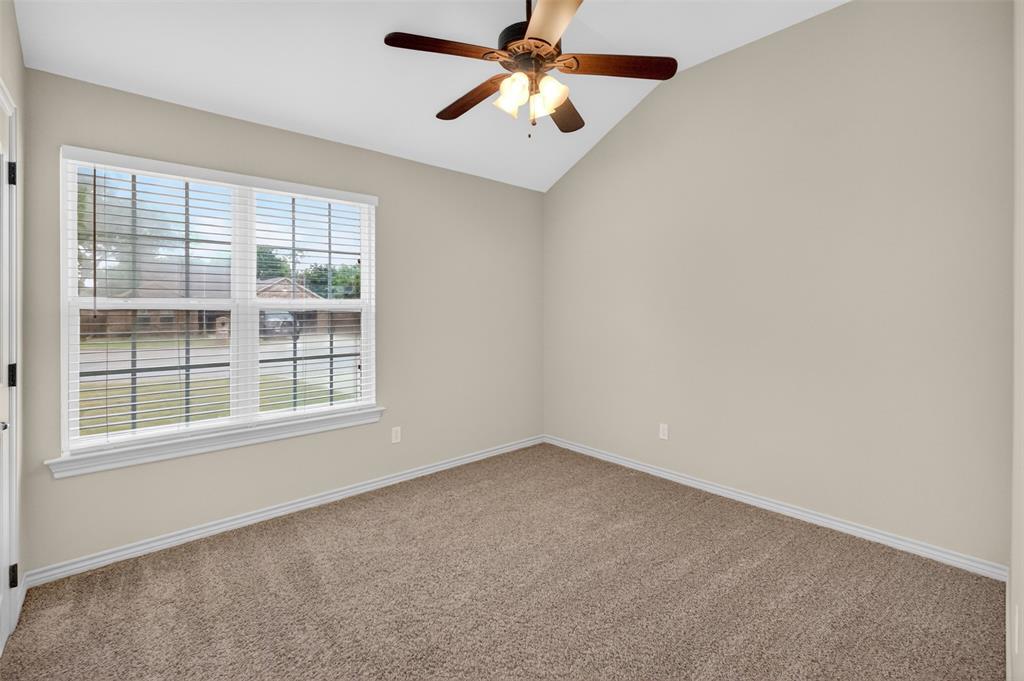 505 East 5th Street Springtown, TX 76082 - Photo 27 of 39 an empty room with a window and a fan