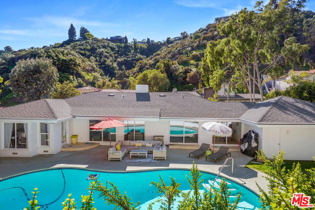 1066 Chantilly Road Los Angeles, CA 90077 - Photo 12 of 12 a view of house with outdoor seating and city view