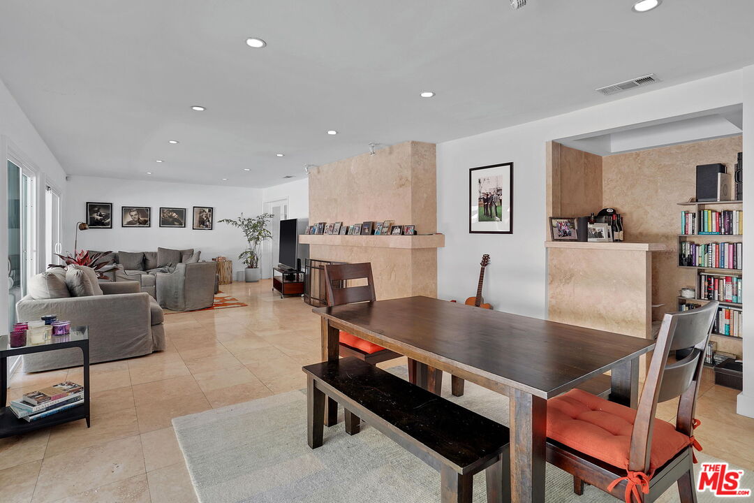 1066 Chantilly Road Los Angeles, CA 90077 - Photo 4 of 12 a living room with furniture a table and kitchen view