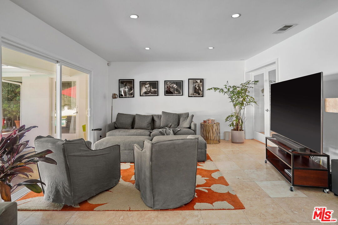 1066 Chantilly Road Los Angeles, CA 90077 - Photo 6 of 12 a living room with furniture and a flat screen tv