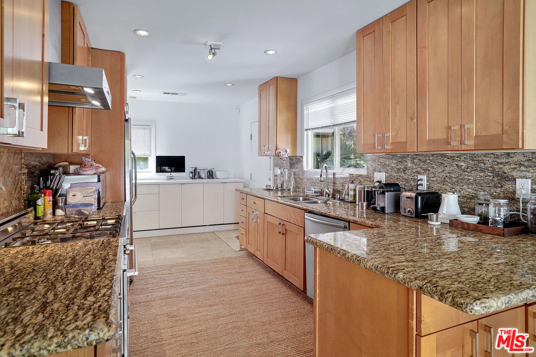 1066 Chantilly Road Los Angeles, CA 90077 - Photo 7 of 12 a kitchen with stainless steel appliances granite countertop a sink stove and cabinets