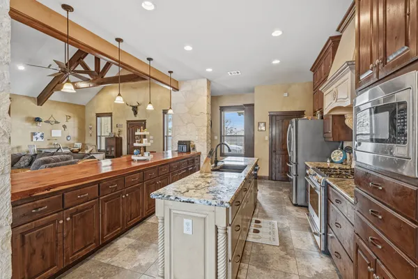 a kitchen with stainless steel appliances granite countertop a sink and cabinets