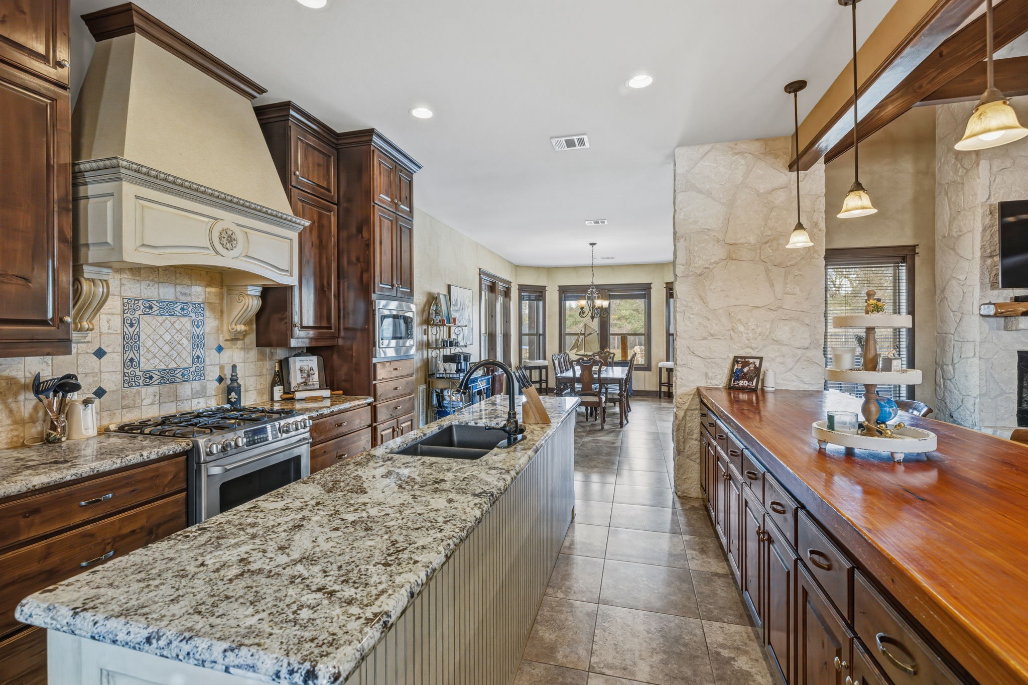 4999 Pin Oak Road Franklin, TX 77856 - Photo 15 of 47 a large kitchen with counter top space a sink stainless steel appliances and cabinets