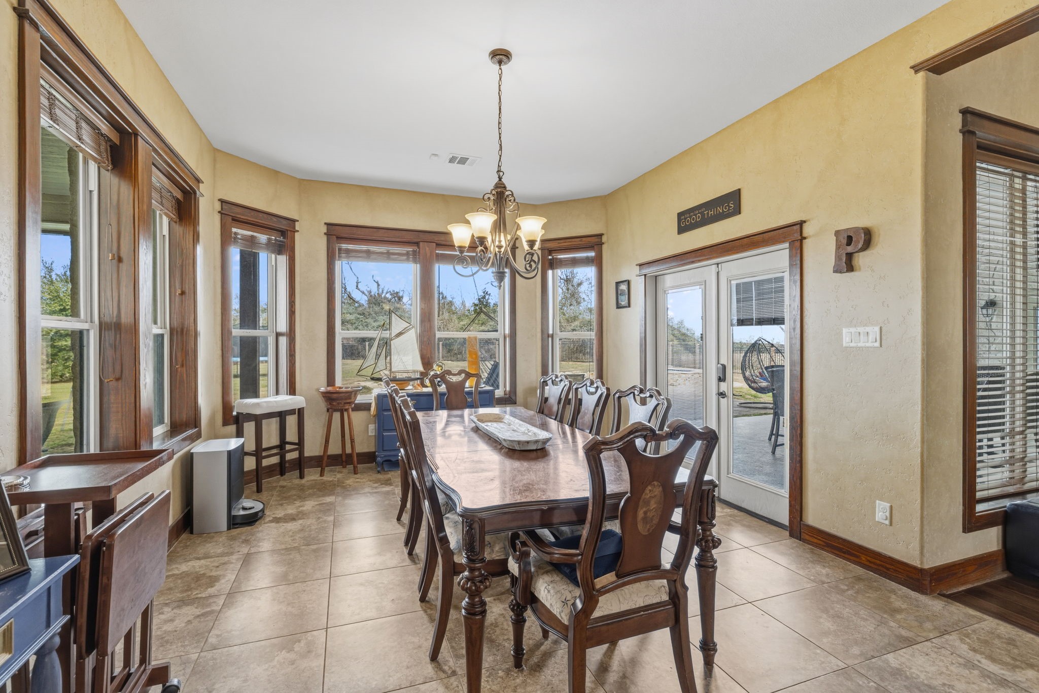 4999 Pin Oak Road Franklin, TX 77856 - Photo 16 of 47 a view of a dining room with furniture large windows and wooden floor