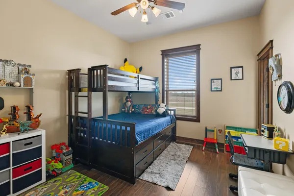a bedroom with bed and a baby crib
