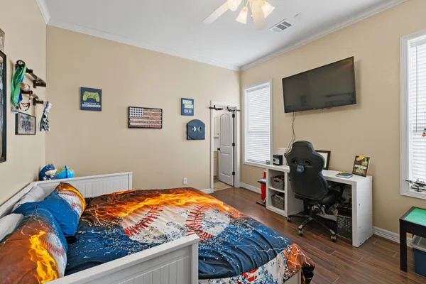 a bedroom with a bed and a flat screen tv