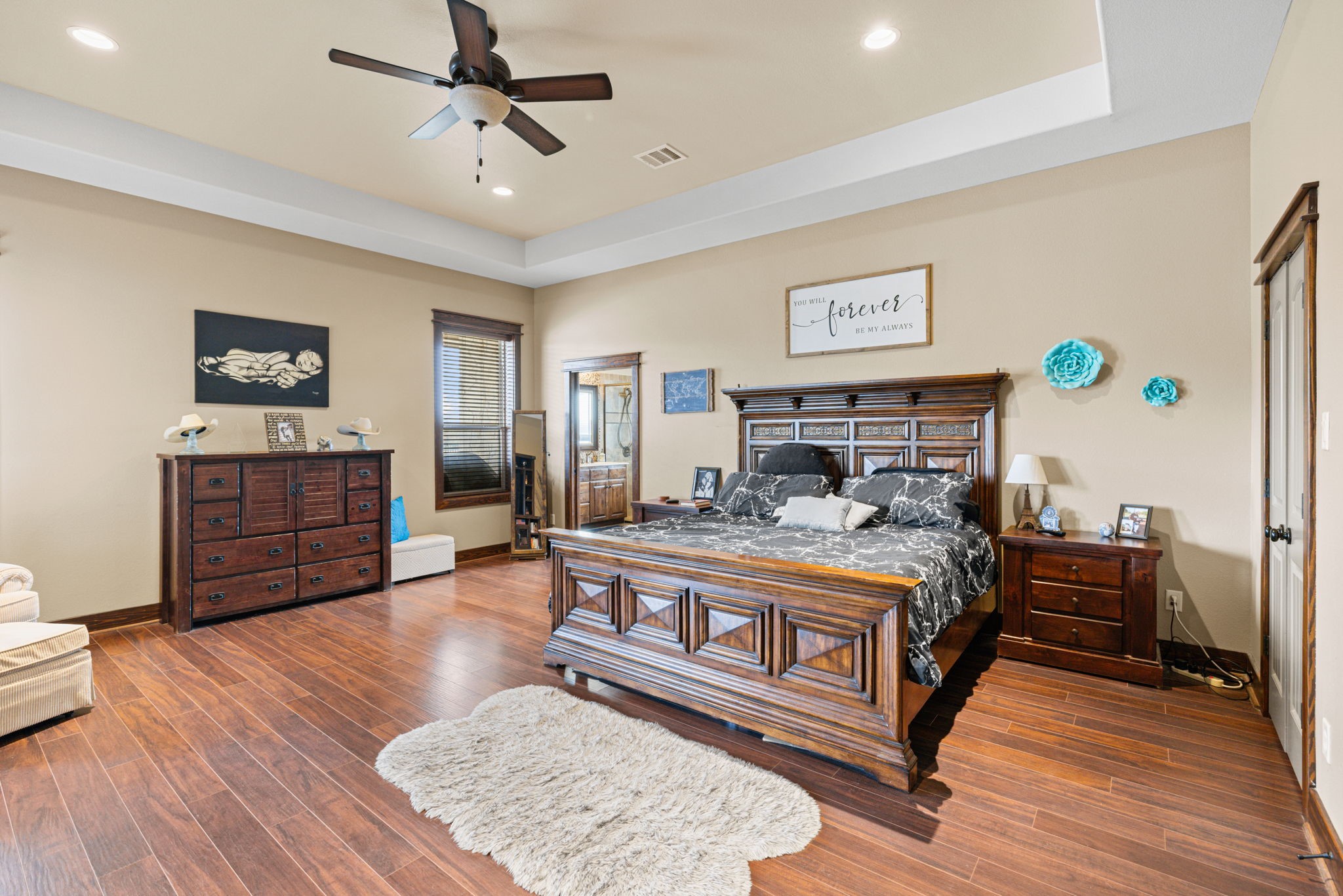 4999 Pin Oak Road Franklin, TX 77856 - Photo 26 of 47 a spacious bedroom with a bed and wooden floor