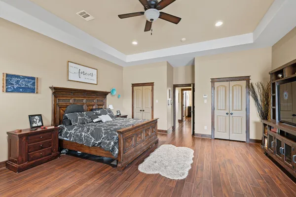 a bedroom with a bed and a flat screen tv