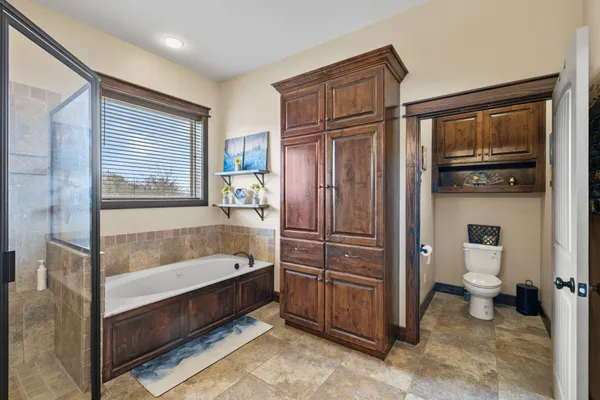 a bathroom with a tub toilet a sink and mirror