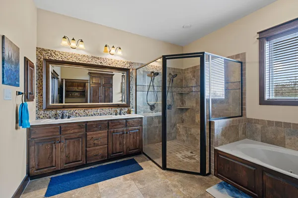 a bathroom with a tub sink and mirror