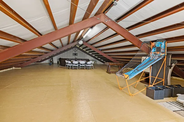 a view of an empty room with wooden stairs