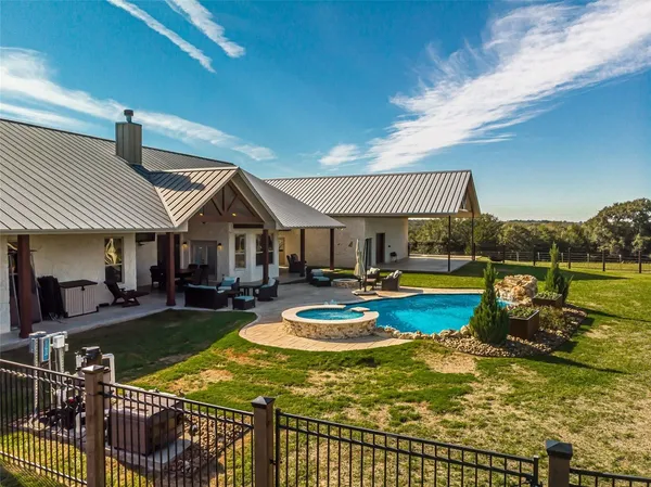 a view of a house with swimming pool and sitting area