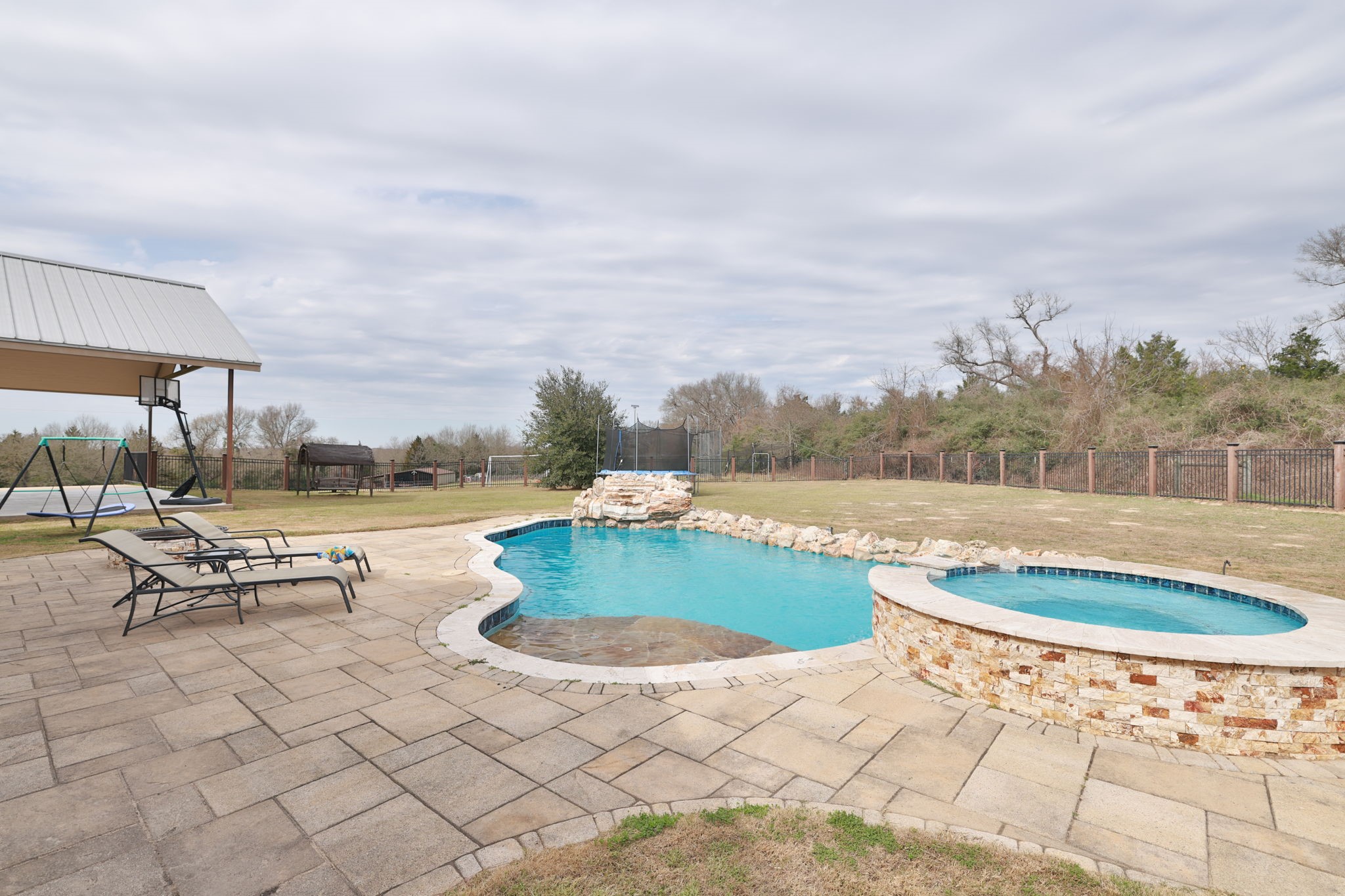 4999 Pin Oak Road Franklin, TX 77856 - Photo 38 of 47 a view of a swimming pool with a lounge chair