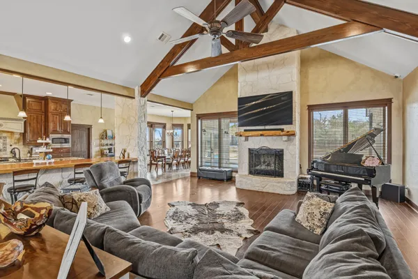 a living room with furniture large window and flat screen tv