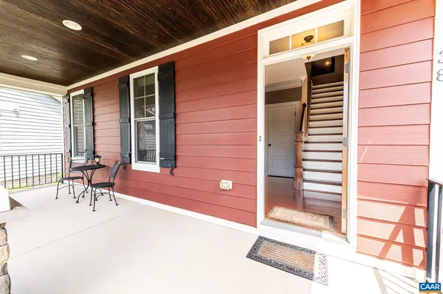 a living room with furniture and a ceiling fan
