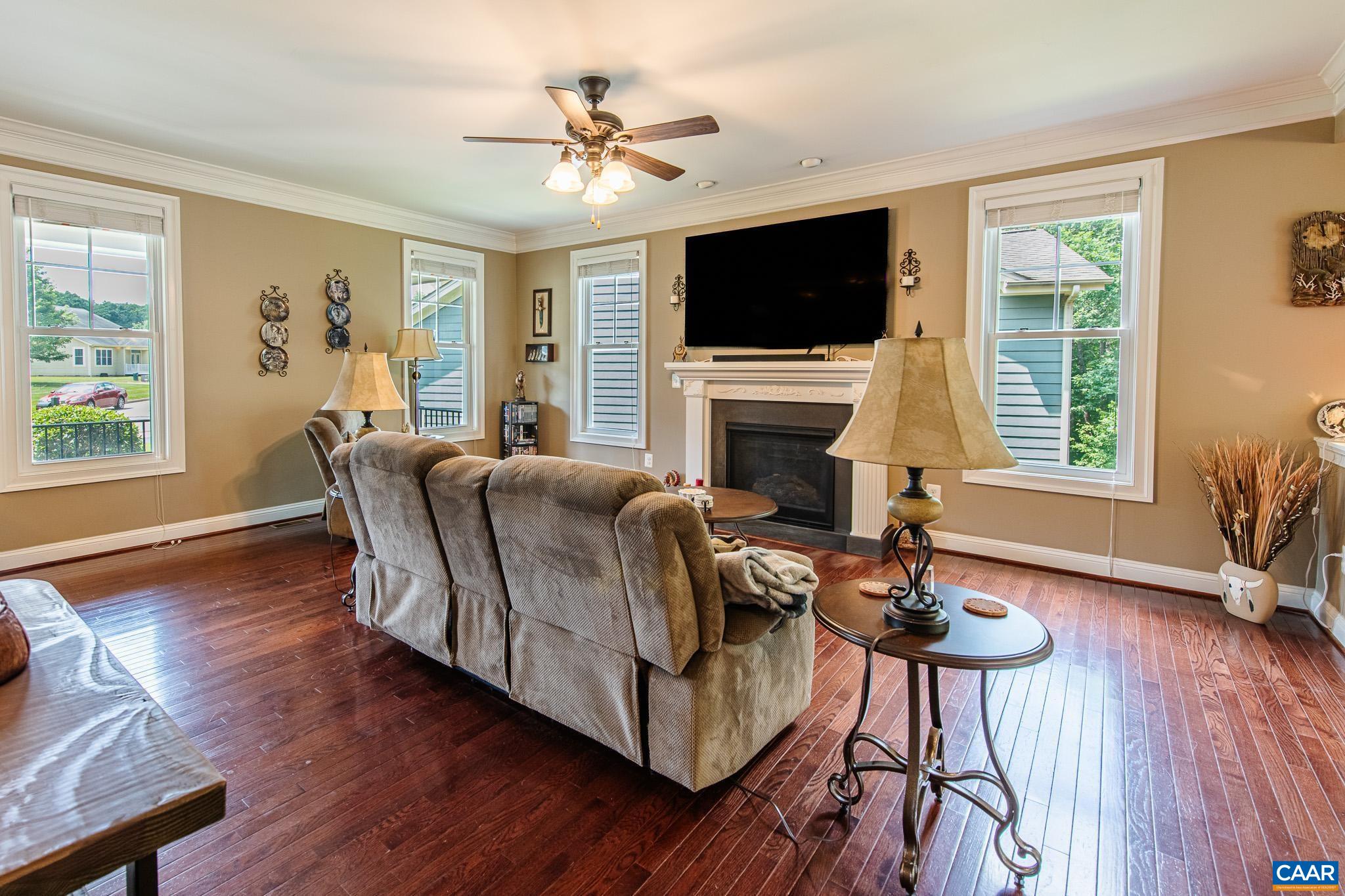 38 Timber Ridge Court Zion Crossroads, VA 22942 - Photo 22 of 72 a living room with furniture a fireplace and a flat screen tv
