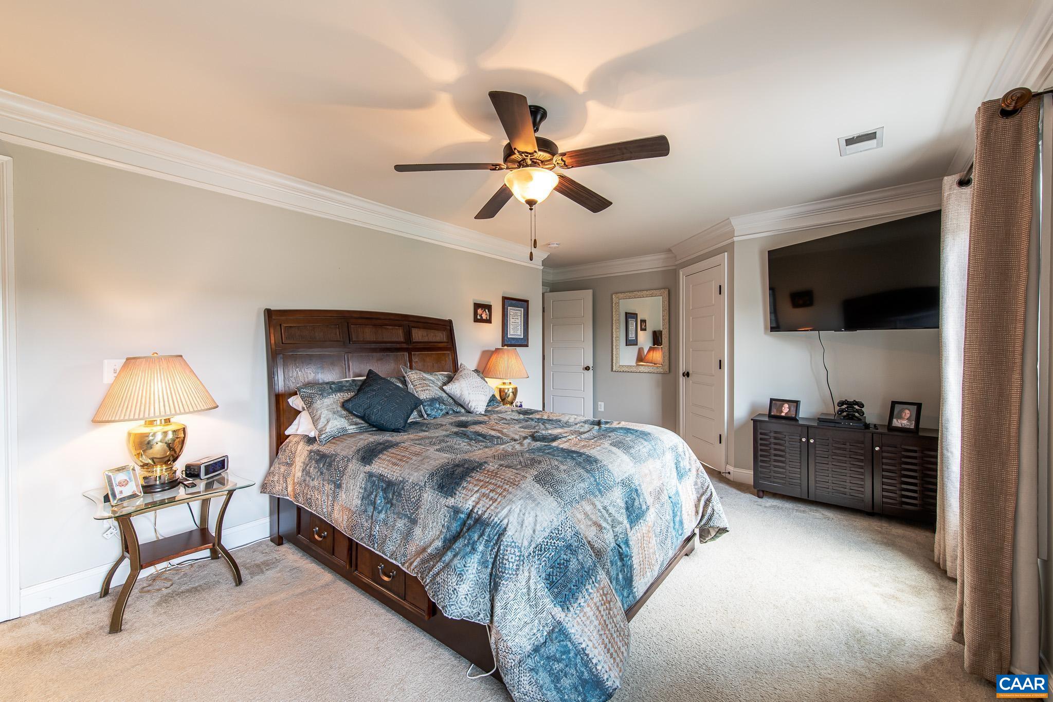 38 Timber Ridge Court Zion Crossroads, VA 22942 - Photo 38 of 72 a bedroom with a bed and a chandelier