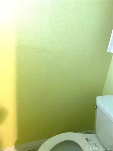 a white toilet sitting next to a small sink