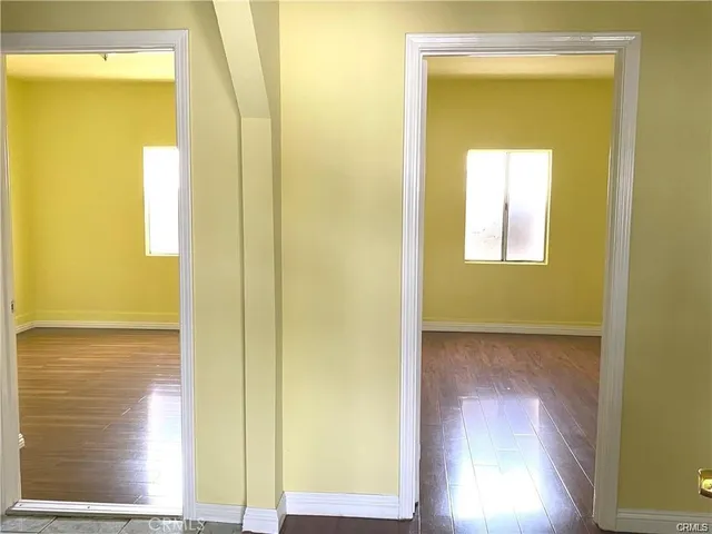 a view of a hallway with wooden floor