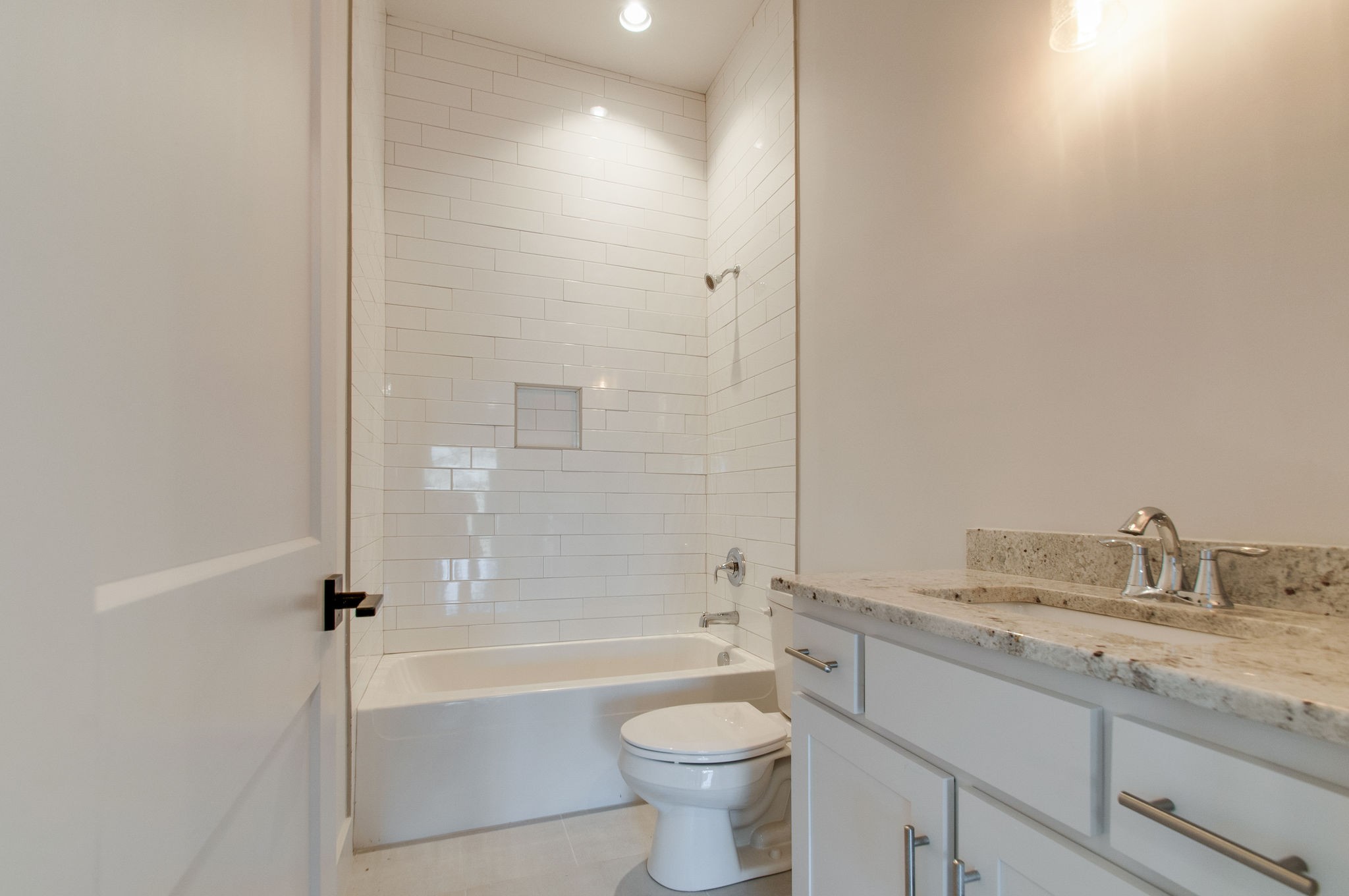929 Mitchell Road Nashville, TN 37206 - Photo 37 of 48 a bathroom with a granite countertop toilet a sink and bathtub