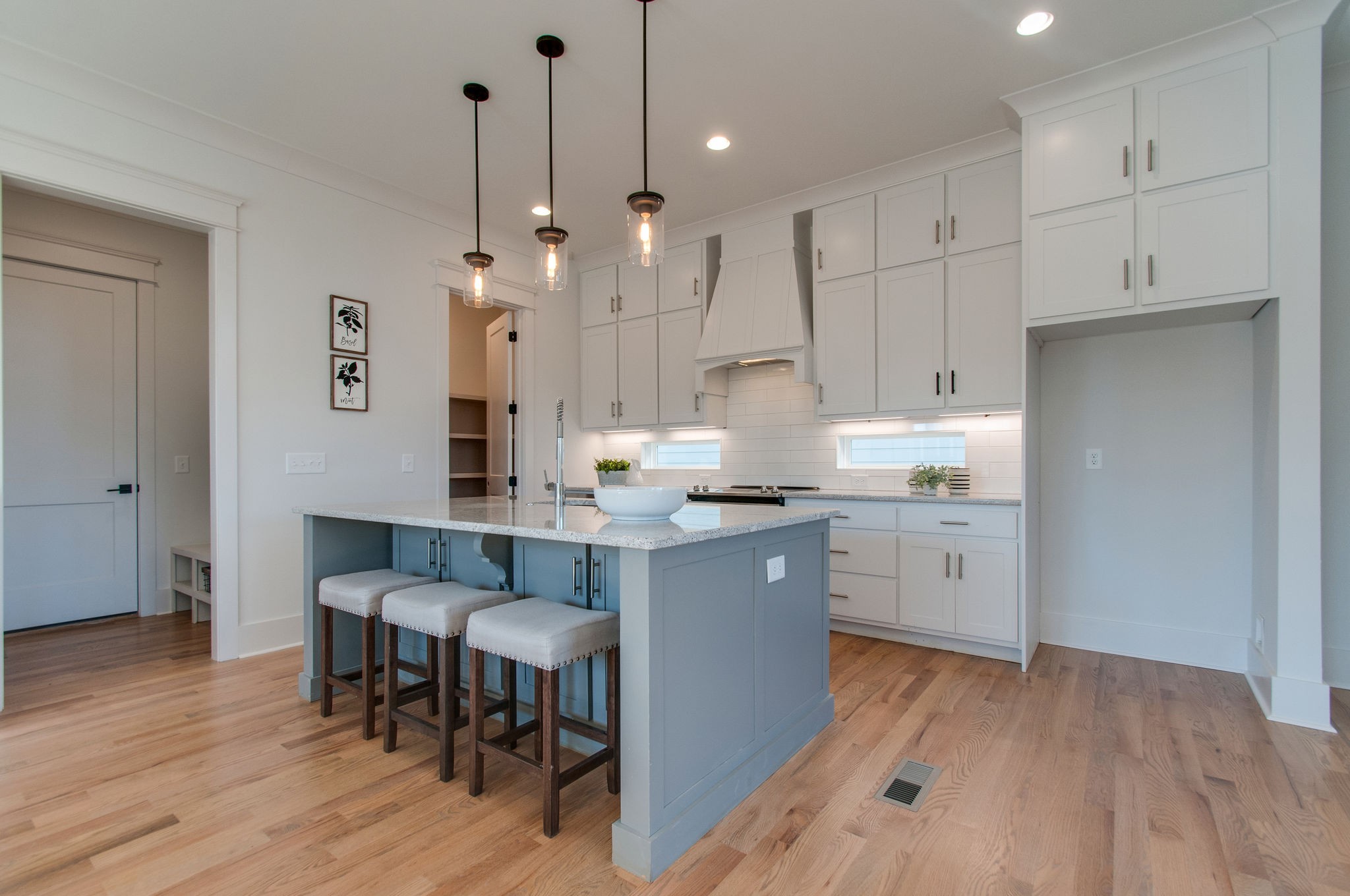 929 Mitchell Road Nashville, TN 37206 - Photo 8 of 48 a kitchen with kitchen island granite countertop a sink cabinets and wooden floor