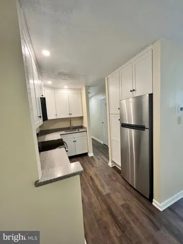 a kitchen with stainless steel appliances a refrigerator and a stove top oven