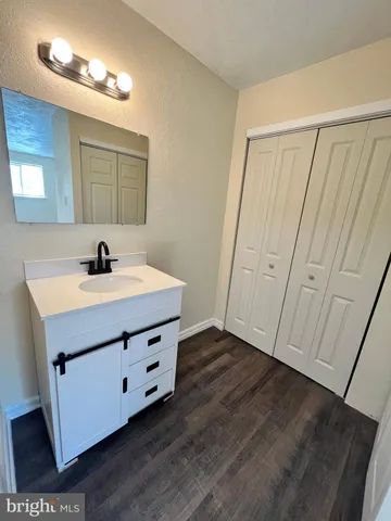 a bathroom with a sink a mirror and vanity