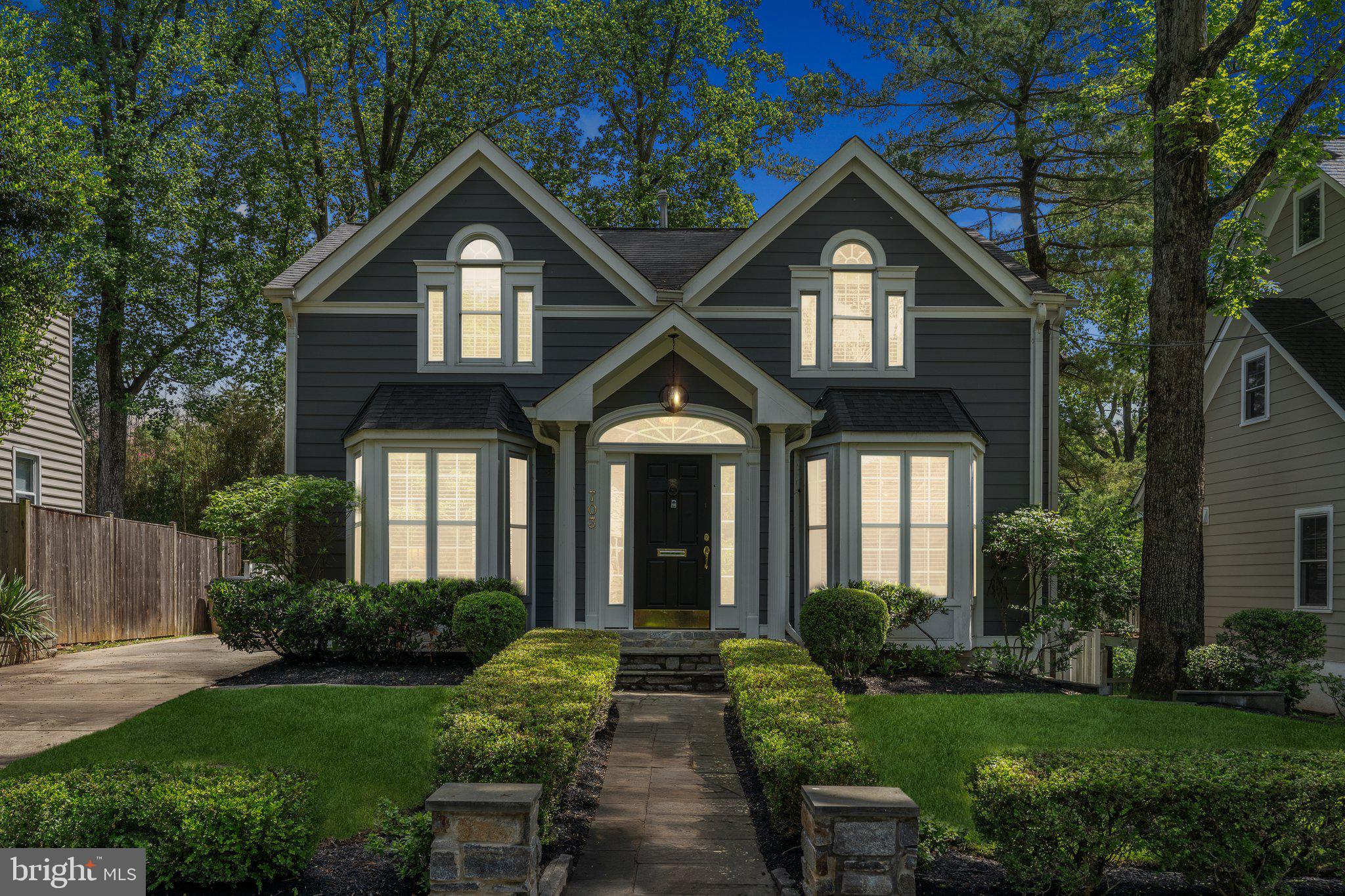 a view of a house with brick walls and a yard in front of it