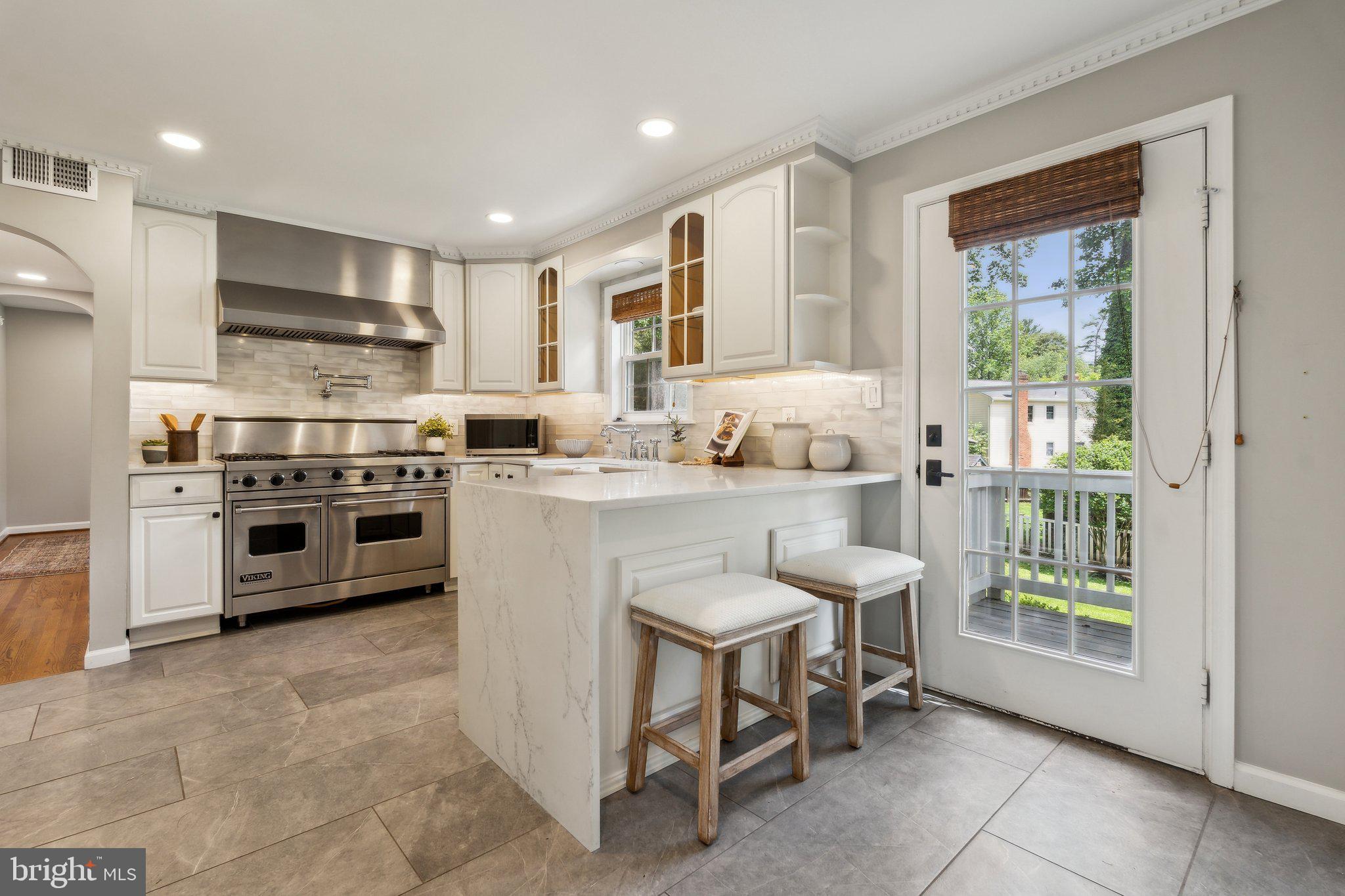 703 Roxboro Road Rockville, MD 20850 - Photo 12 of 55 a kitchen with appliances cabinets and a sink