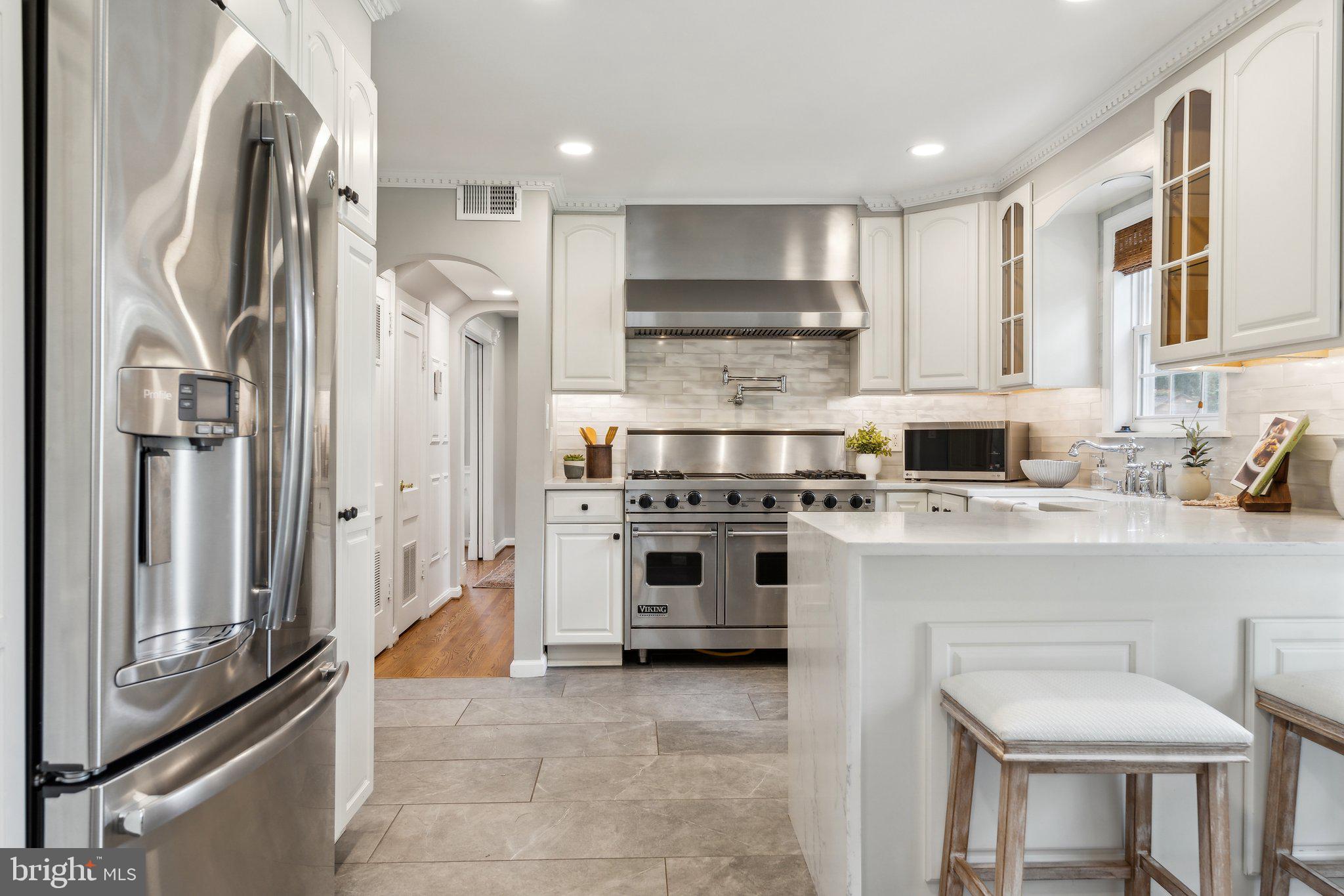 703 Roxboro Road Rockville, MD 20850 - Photo 13 of 55 a kitchen with stainless steel appliances a stove a sink and a refrigerator
