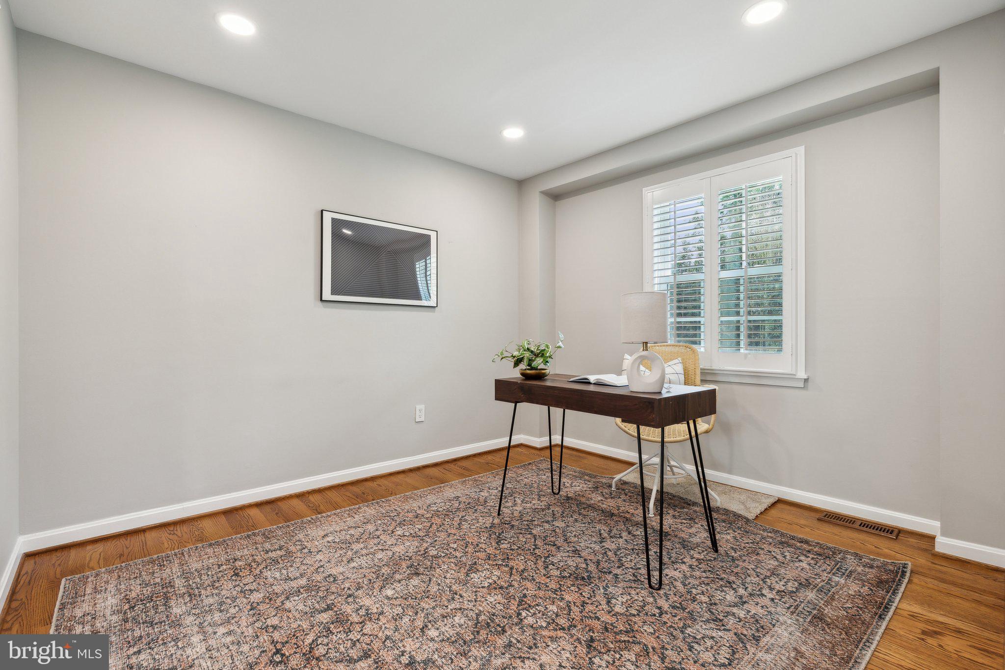 703 Roxboro Road Rockville, MD 20850 - Photo 21 of 55 a view of a workspace with wooden floor and a window