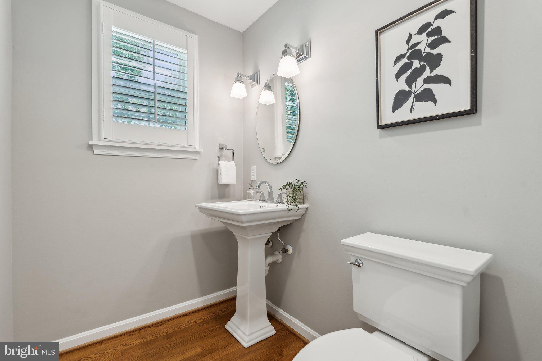 703 Roxboro Road Rockville, MD 20850 - Photo 24 of 55 a bathroom with a toilet a sink and a mirror