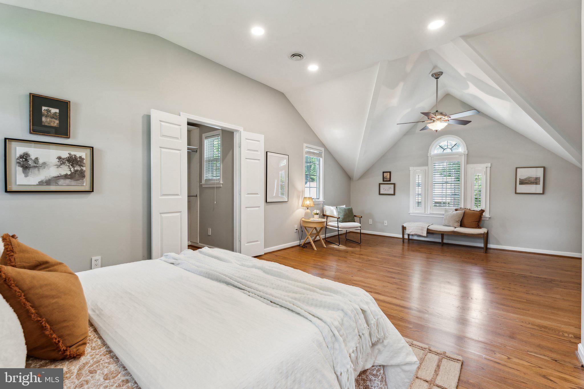 703 Roxboro Road Rockville, MD 20850 - Photo 32 of 55 a spacious bedroom with a bed a couch and large windows