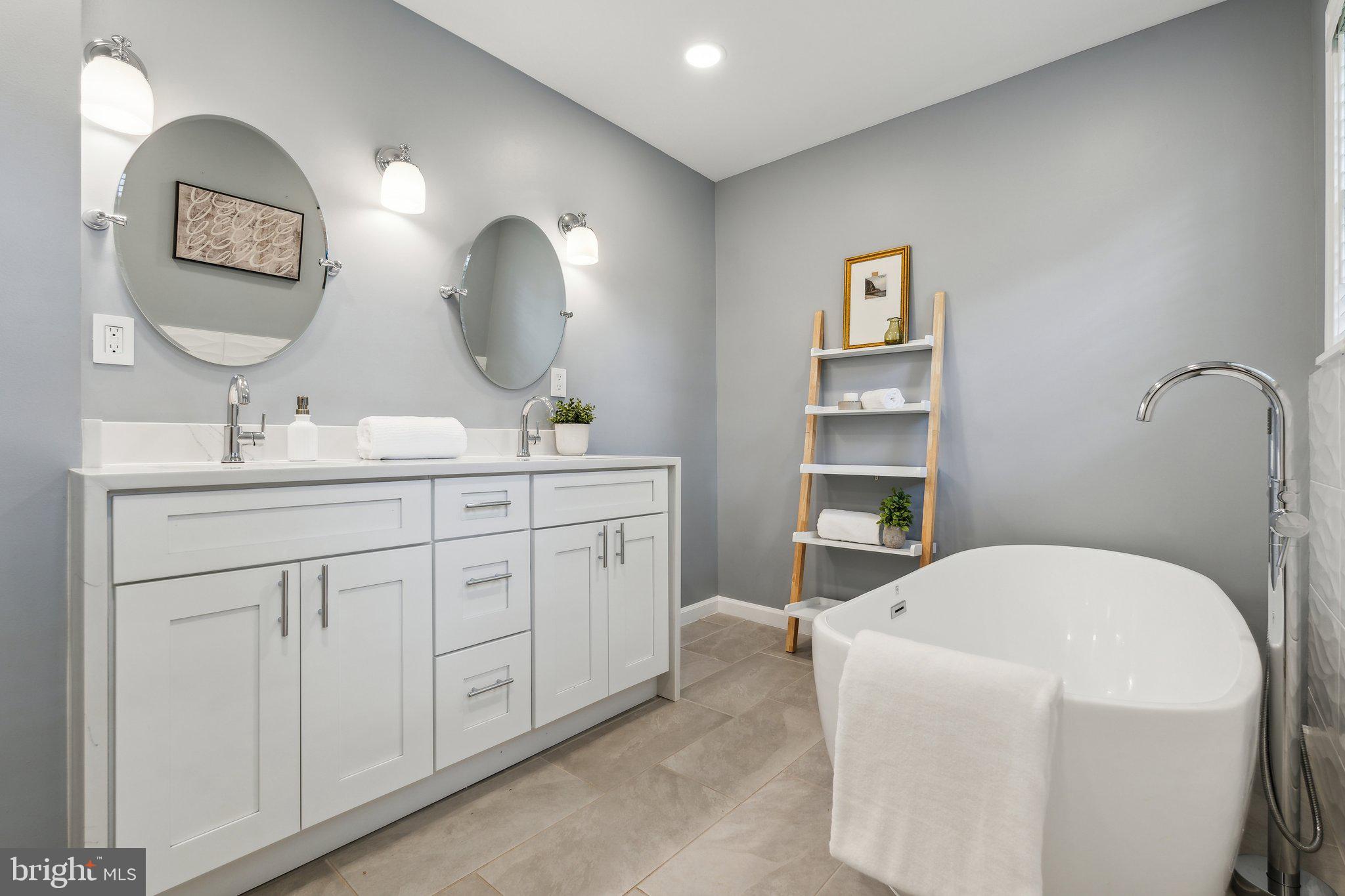 703 Roxboro Road Rockville, MD 20850 - Photo 37 of 55 a spacious bathroom with a double vanity sink and a mirror