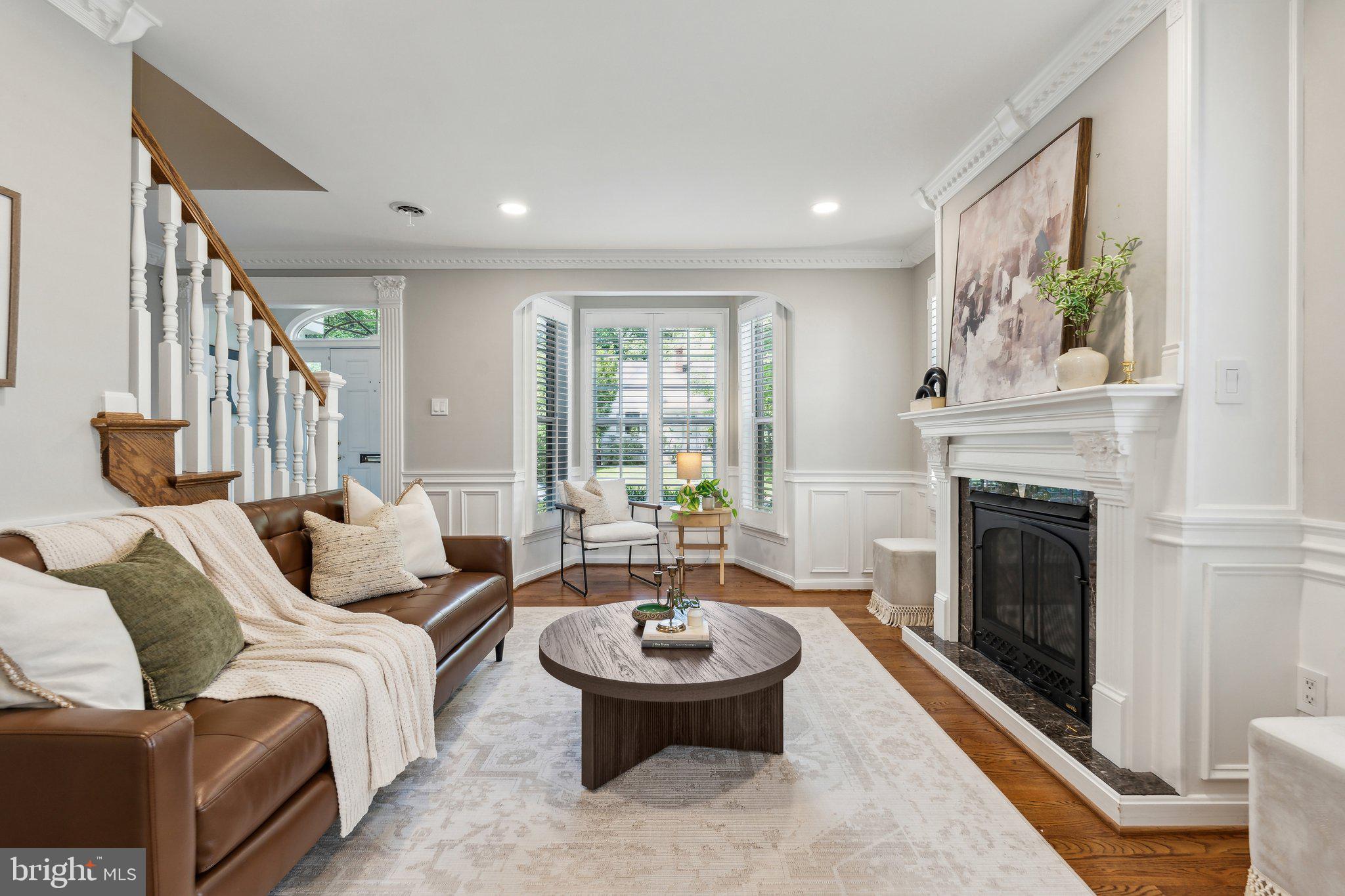 703 Roxboro Road Rockville, MD 20850 - Photo 10 of 55 a living room with furniture a fireplace and a table