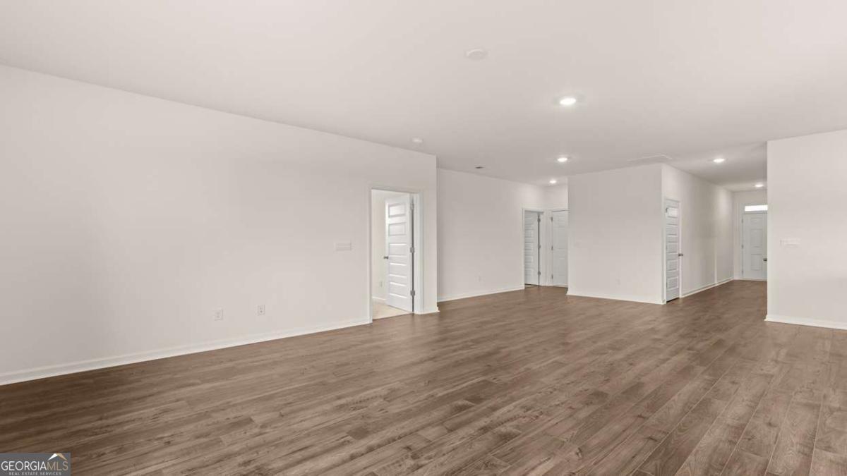 8576 Seabiscuit Road Lithonia, GA 30058 - Photo 5 of 22 a view of an empty room with wooden floor