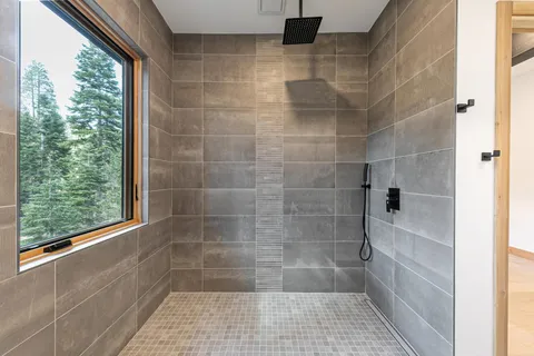 a bathroom with a double vanity sink and a mirror