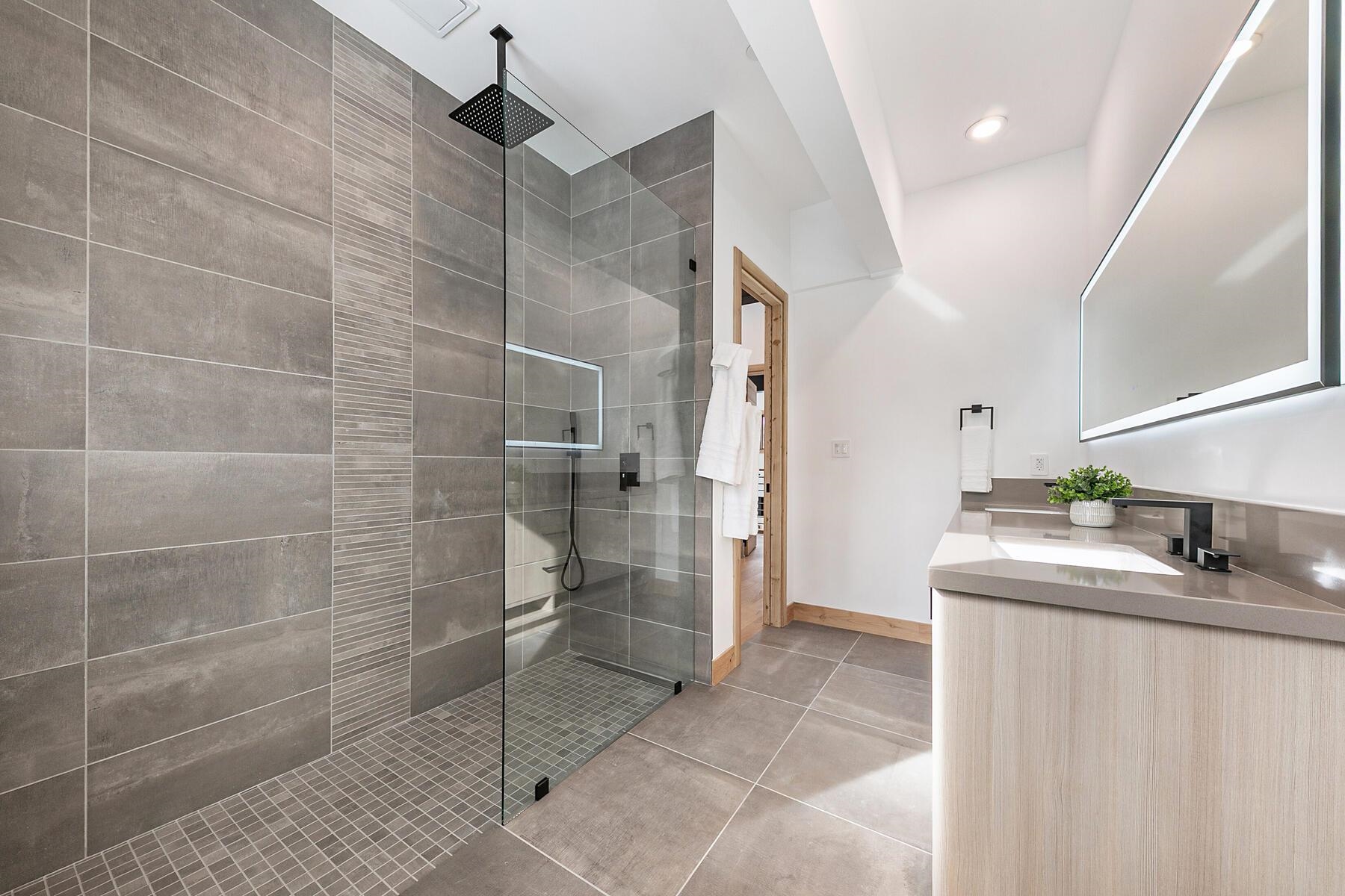 225 Smiley Court Olympic Valley, CA 96146 - Photo 14 of 28 a bathroom with a granite countertop sink a toilet and shower