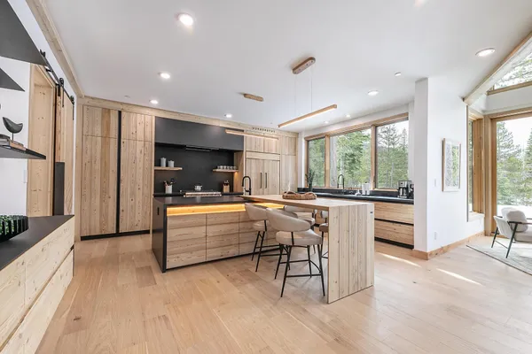 a large kitchen with stainless steel appliances and a large window