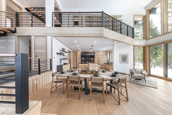 a bedroom with a large bed couch and a large window