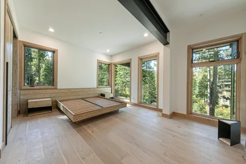 a bedroom with a bed and a large window with outer view