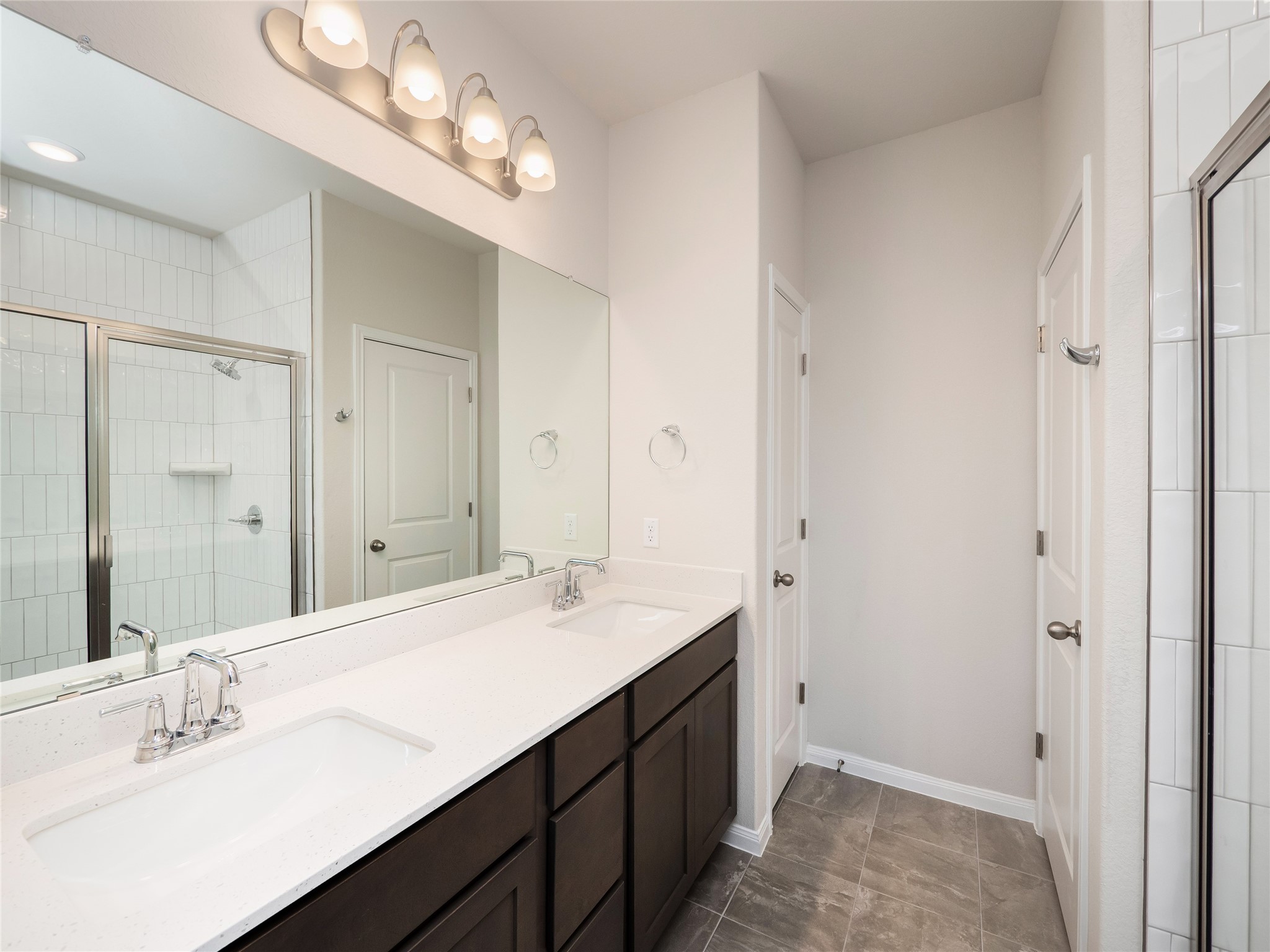 181 Soldier Street Kyle, TX 78640 - Photo 16 of 37 a bathroom with a sink double vanity and a mirror