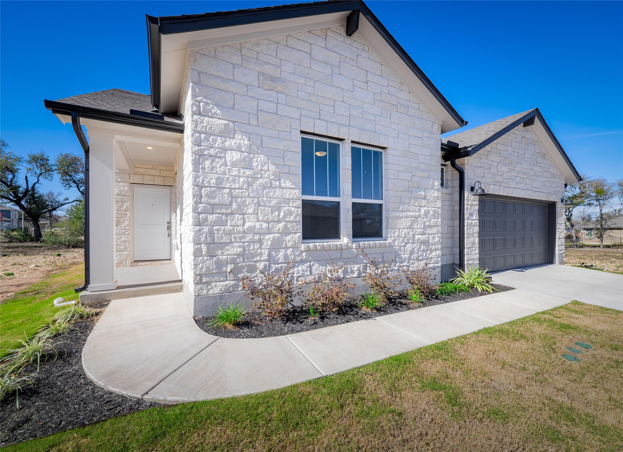 181 Soldier Street Kyle, TX 78640 - Photo 2 of 37 a front view of a house with garden