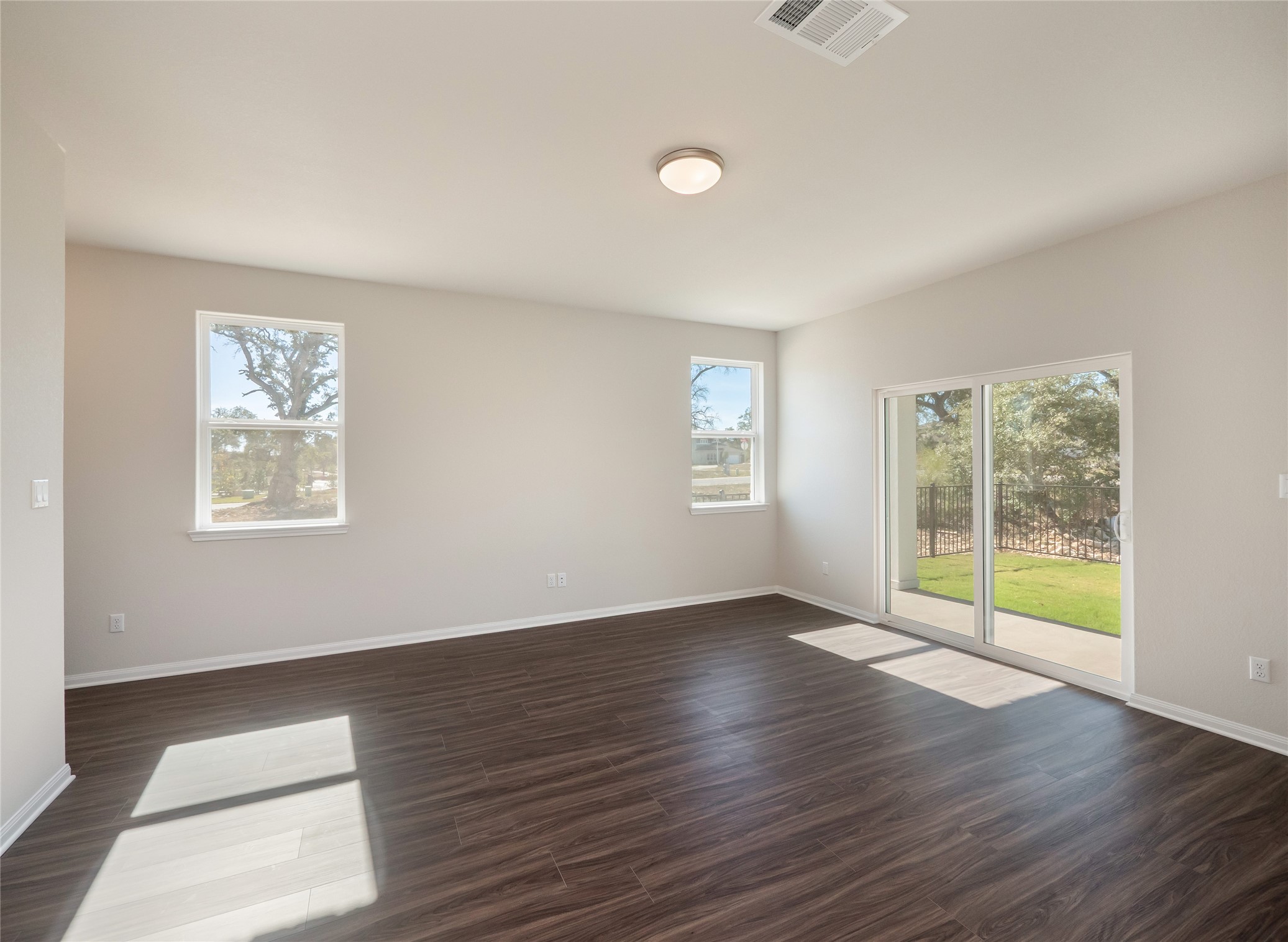 181 Soldier Street Kyle, TX 78640 - Photo 4 of 37 a view of an empty room with wooden floor and a window