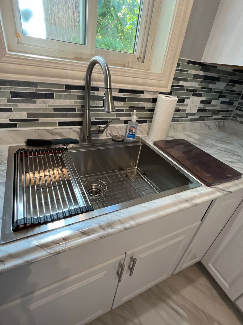 7438 South Champlain Avenue Chicago, IL 60619 - Photo 19 of 41 a close view of sink and washing machine
