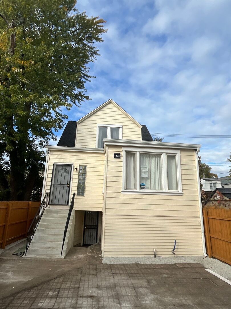 7438 South Champlain Avenue Chicago, IL 60619 - Photo 2 of 41 a front view of a house with a garage