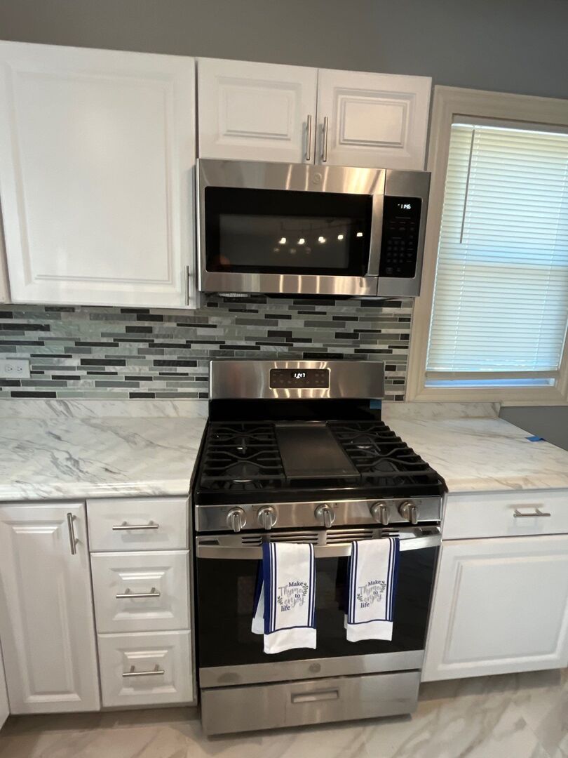 7438 South Champlain Avenue Chicago, IL 60619 - Photo 21 of 41 a stove top oven sitting inside of a kitchen