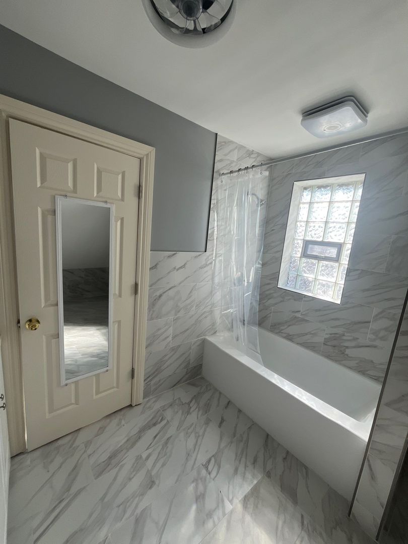 7438 South Champlain Avenue Chicago, IL 60619 - Photo 25 of 41 a bathroom with a tub and a shower