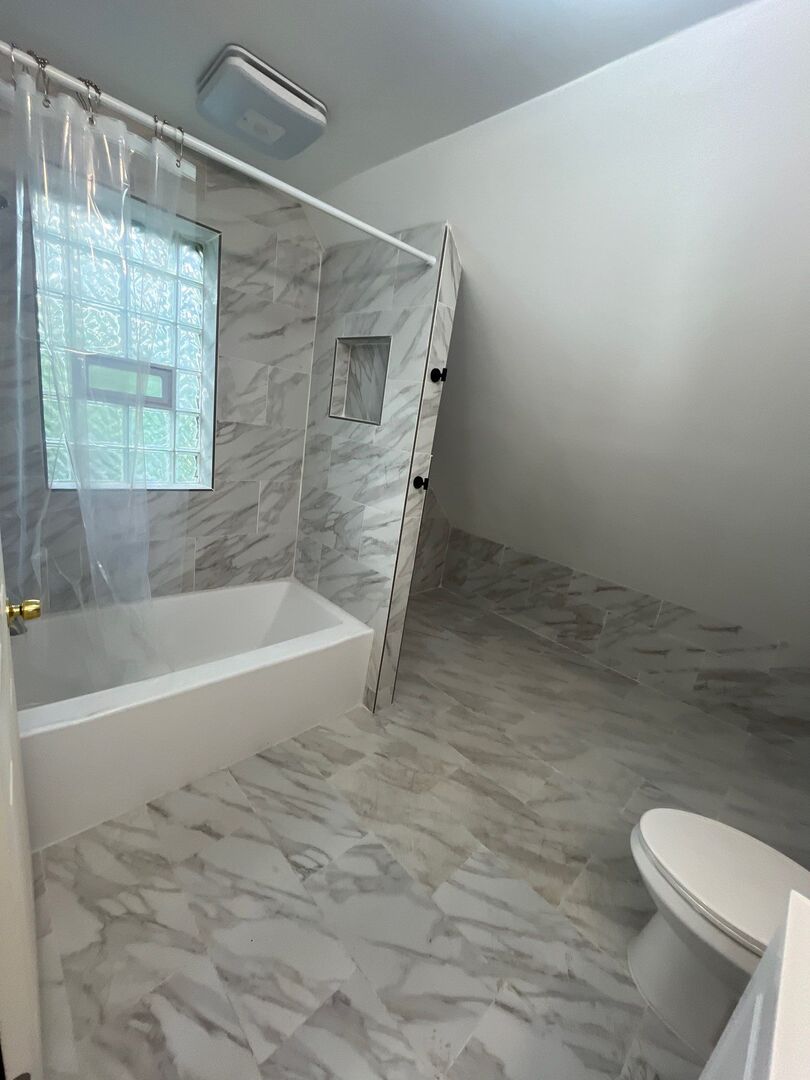 7438 South Champlain Avenue Chicago, IL 60619 - Photo 26 of 41 a bathroom with a toilet and a bathtub